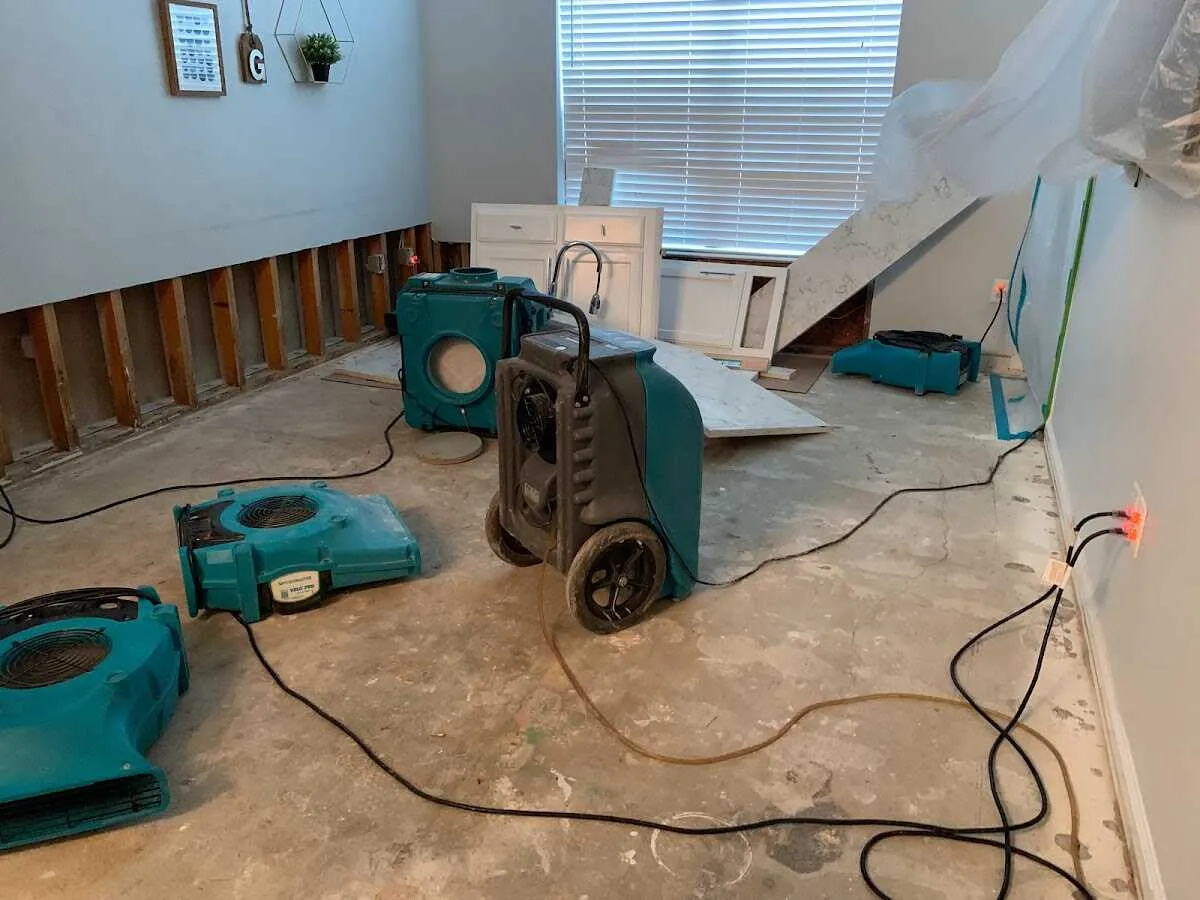 Dehumidifier in flood-cut room for Water Damage Restoration in Logan